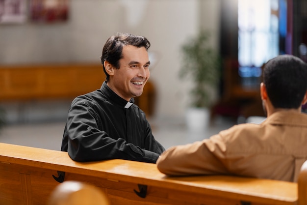 Free photo people visiting and praying in church building