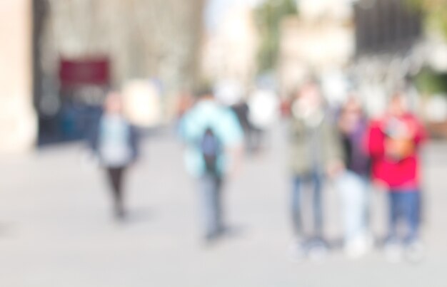 People walking in row out of focus