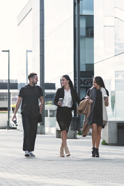 People walking with coffee on street