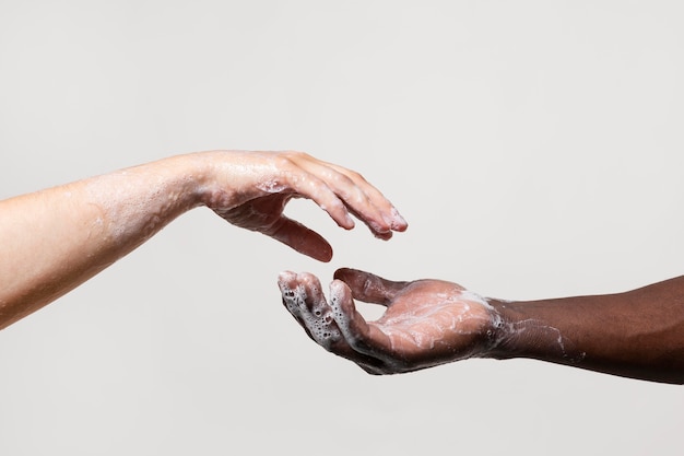 People washing hands with soap