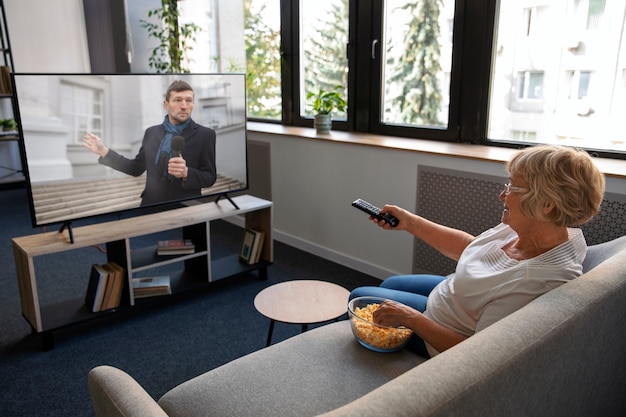 Free photo people watching news on tv