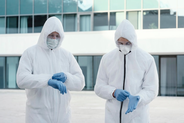 Free photo people wearing prevention suits against a bio-hazard