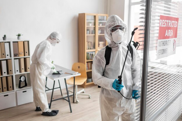 People wearing protective equipment for disinfecting a dangerous area