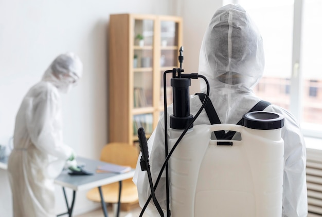 People wearing protective equipment for disinfecting a dangerous area