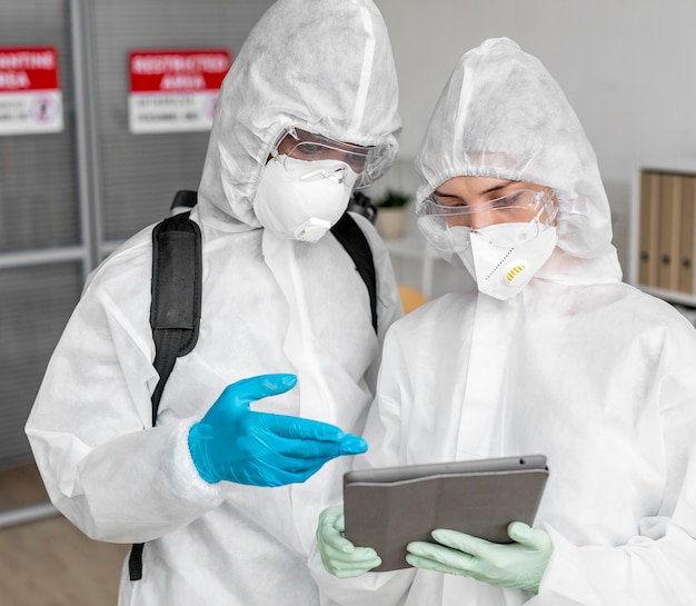 People wearing protective equipment for disinfecting a dangerous area