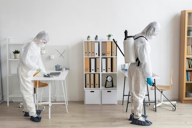 people wearing protective equipment for disinfecting a dangerous area