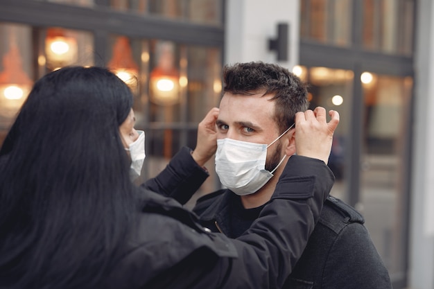 People wearing a protective mask standing on the street