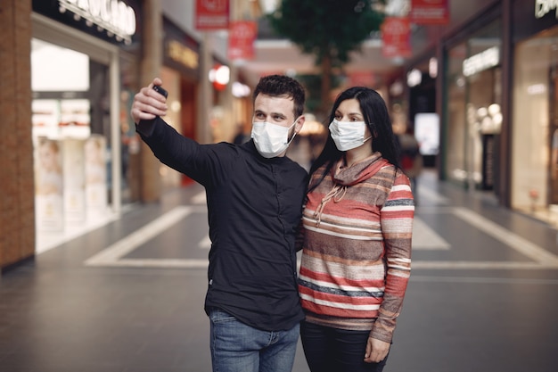 Free photo people wearing a protective mask taking a selfie