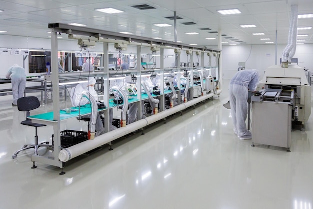 People in white isolating costumes working in laboratory