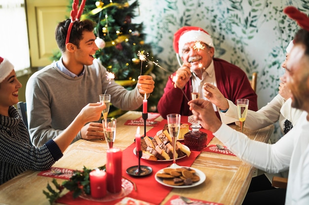 People with Bengal fires at festive table