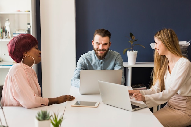 People with laptops in office