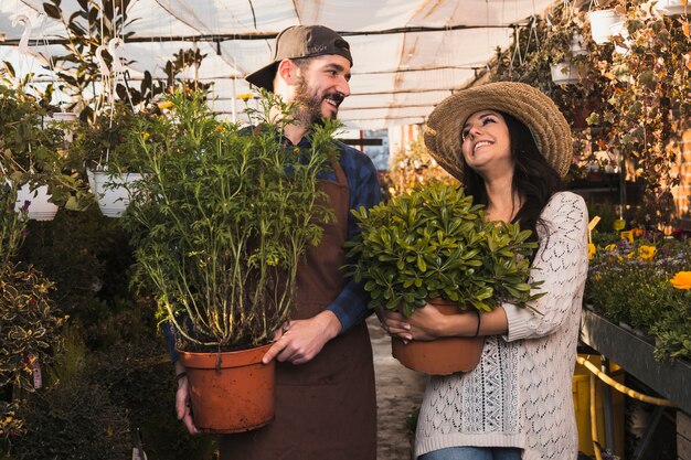 People with pots in glasshouse