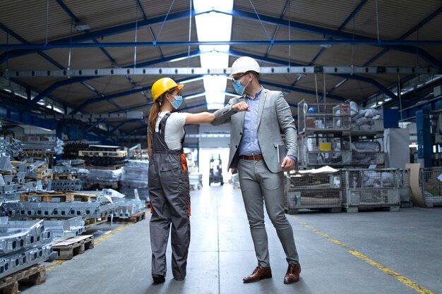 People at work greeting each other with elbow bump due to global corona virus pandemic and danger of infection