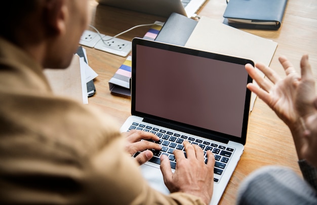 People working on a laptop in a meeting