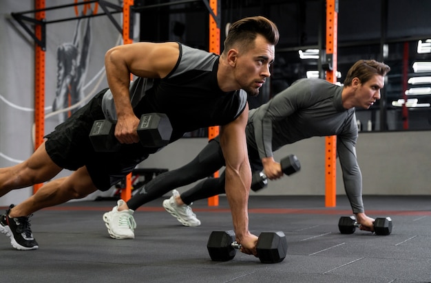 People working out indoors together with dumbbells