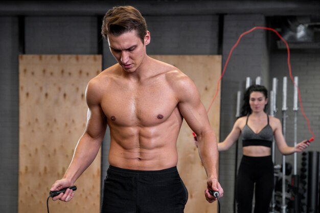 People working out indoors together with jump rope