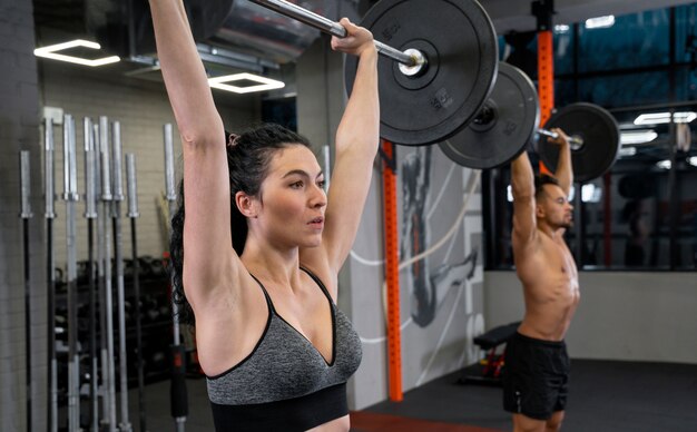 People working out indoors together with weights