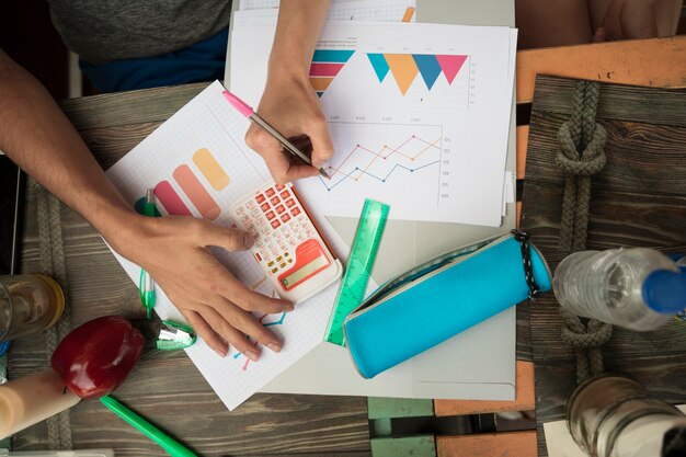 People working with diagrams and graphics on table