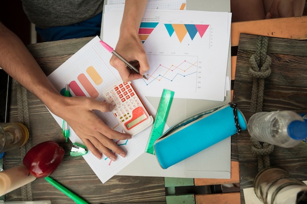 People working with diagrams and graphics on table