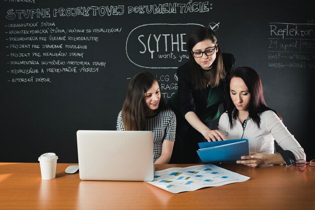 People working with documents and laptop