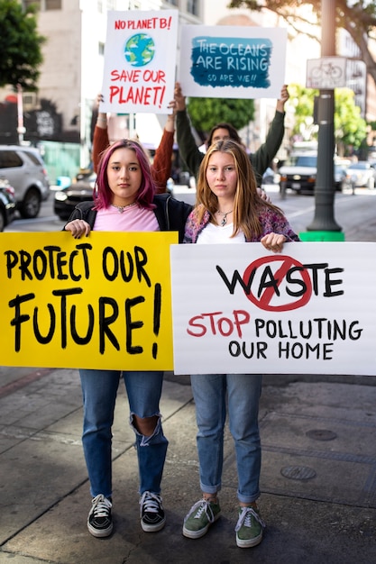 People at a world environment day protest outdoors with placards