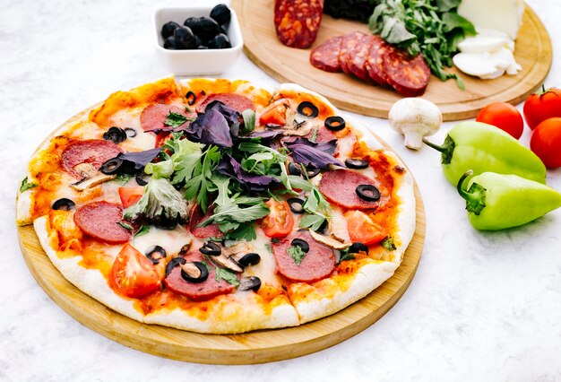 Pepperoni pizza with olive tomato mushroom and herbs