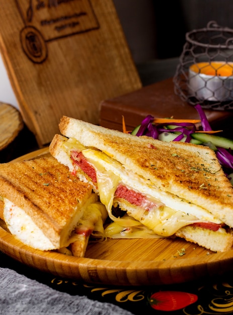 Pepperoni toast with cheese served win bamboo plate