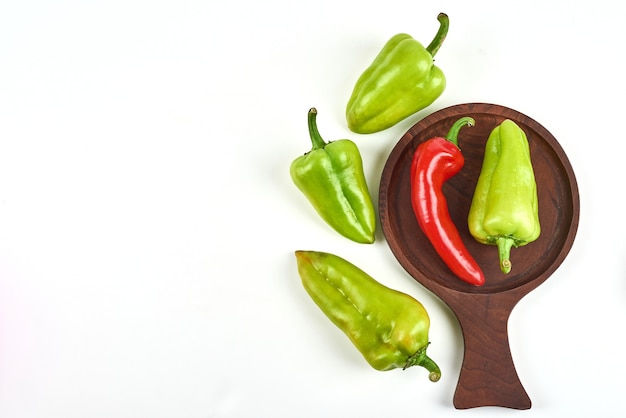 Peppers on a wooden platter.