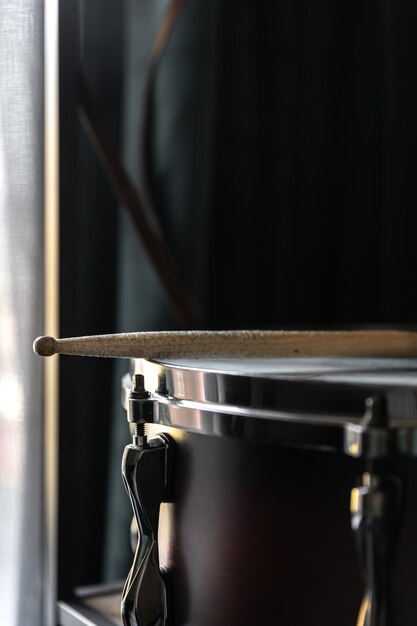 Percussion Instrument, snare drum with sticks close up in the room interior.