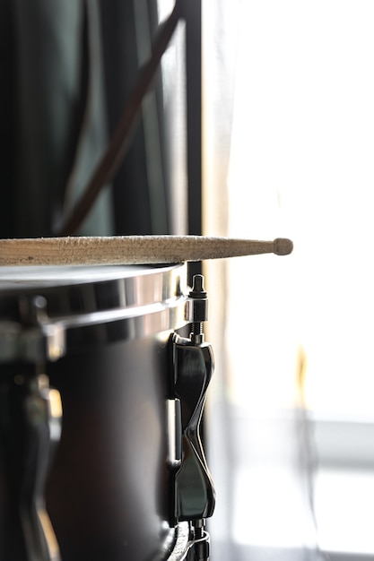 Percussion Instrument, snare drum with sticks close up in the room interior.