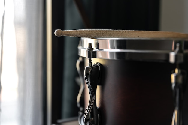 Percussion Instrument, snare drum with sticks close up in the room interior.