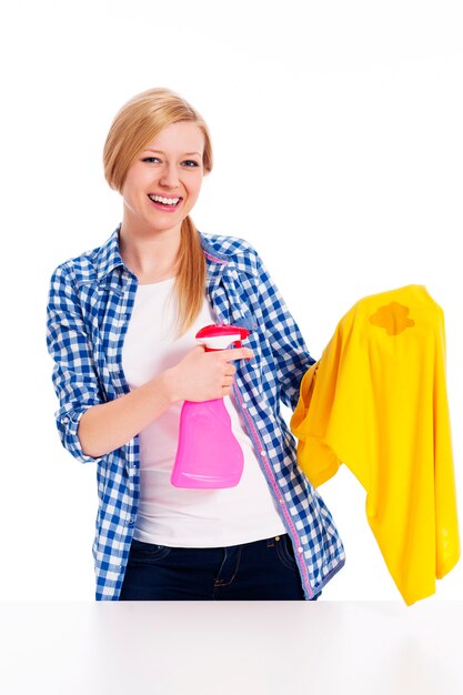 Perfect housewife cleaning the stain with shirts