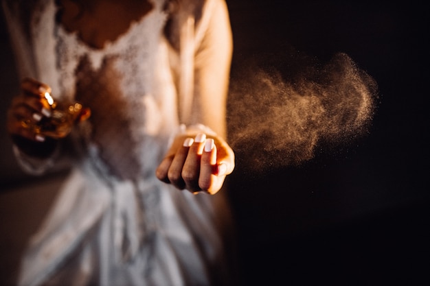 Premium Photo | Perfume spray above woman's hand