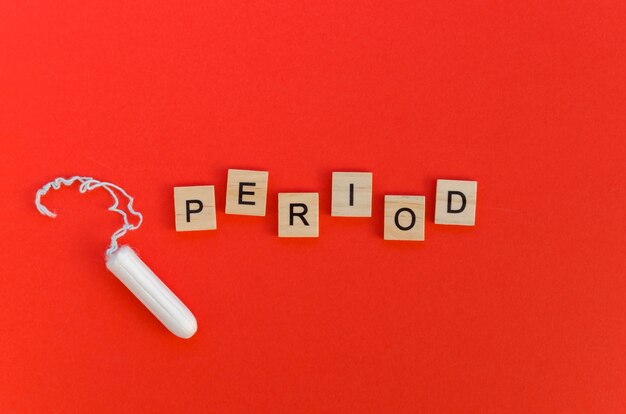 Period word with scrabble letters and tampon