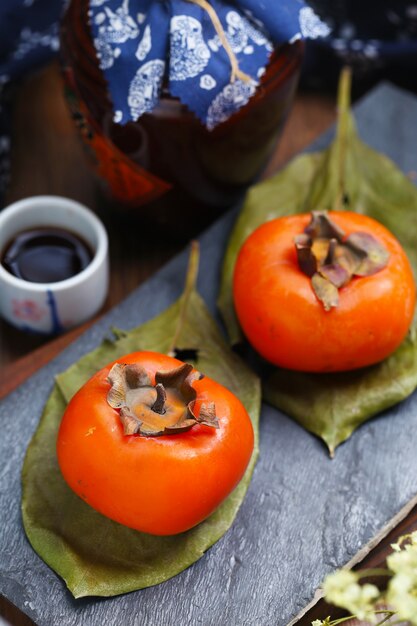 persimmons on stone board