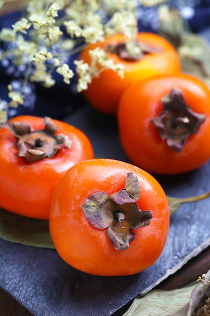 persimmons on stone board