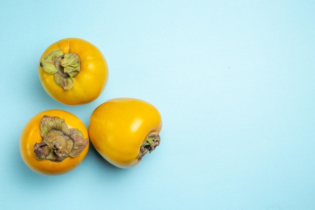 persimmons three appetizing persimmons on the left side of the table