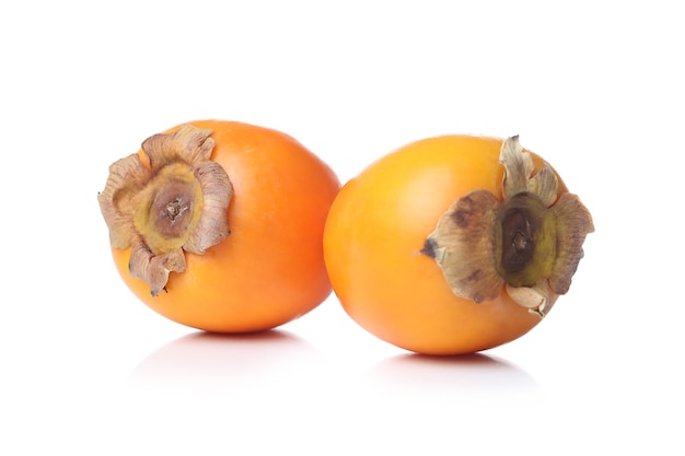 Persimmons on a white surface