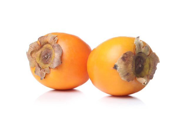 Persimmons on a white surface