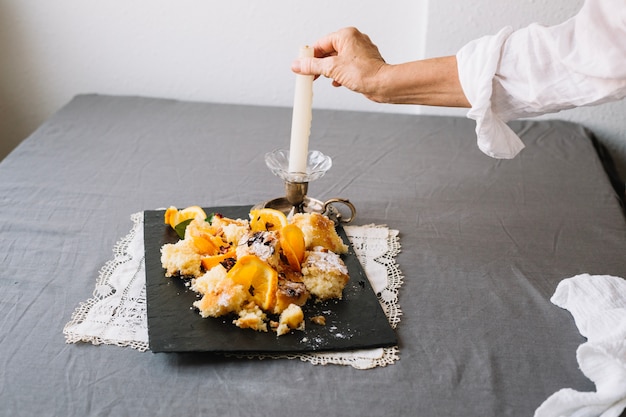 Person arranging dessert on table