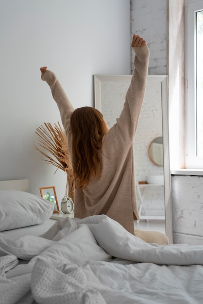 Person in bedroom with bed decor