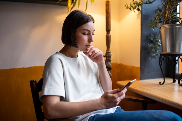 Free photo person in a cafe enjoying a book