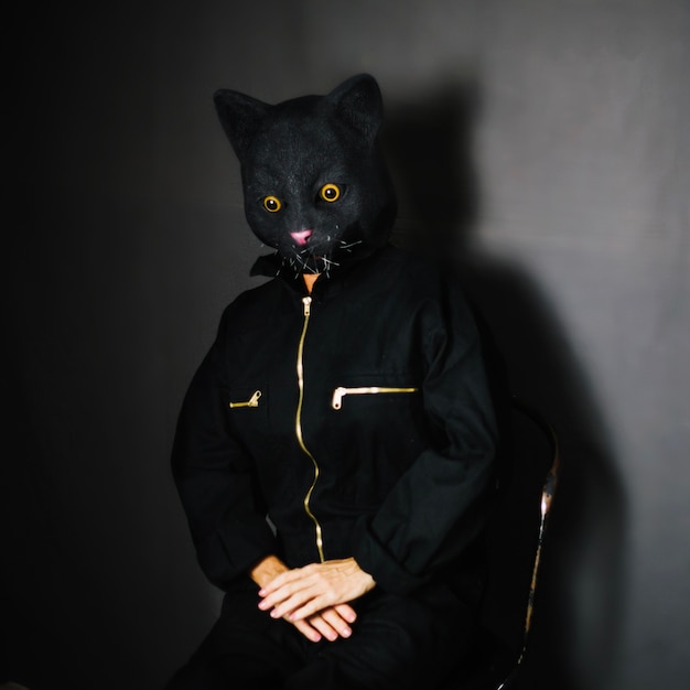 Person in cat mask sitting