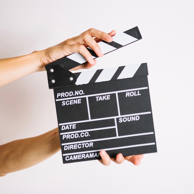 Person clapping clapperboard