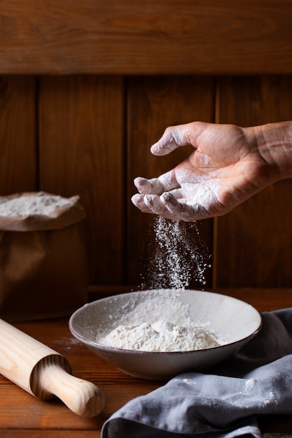 Person cooking with flour