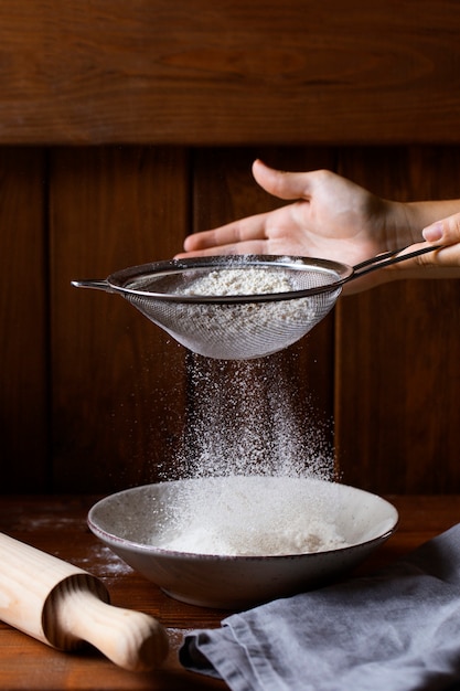 Person cooking with flour