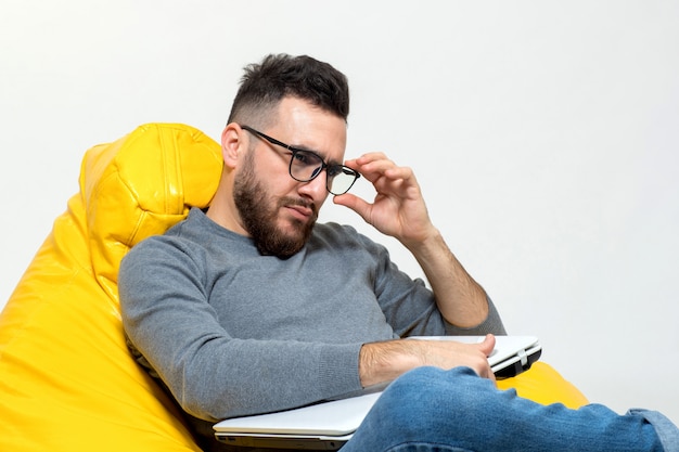 Free photo a person corrects glasses that he put on