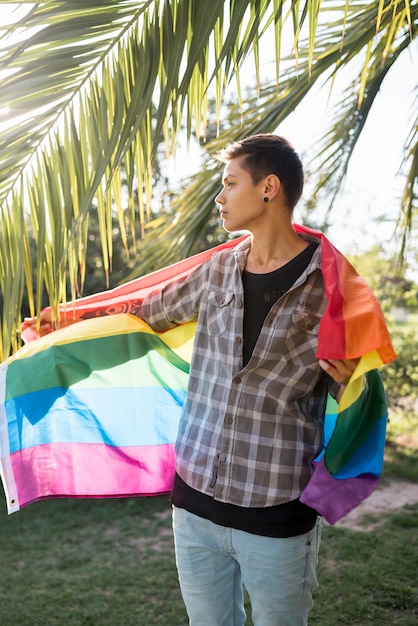 Person covering in LGBT flag