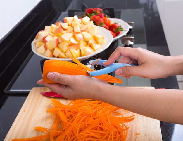 Person cutting carrots