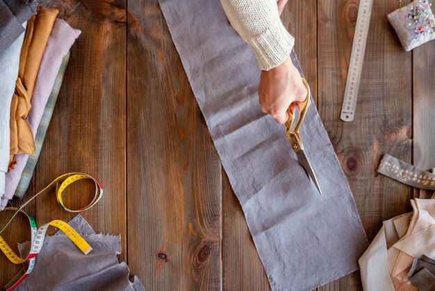 Person cutting fabric for sewing